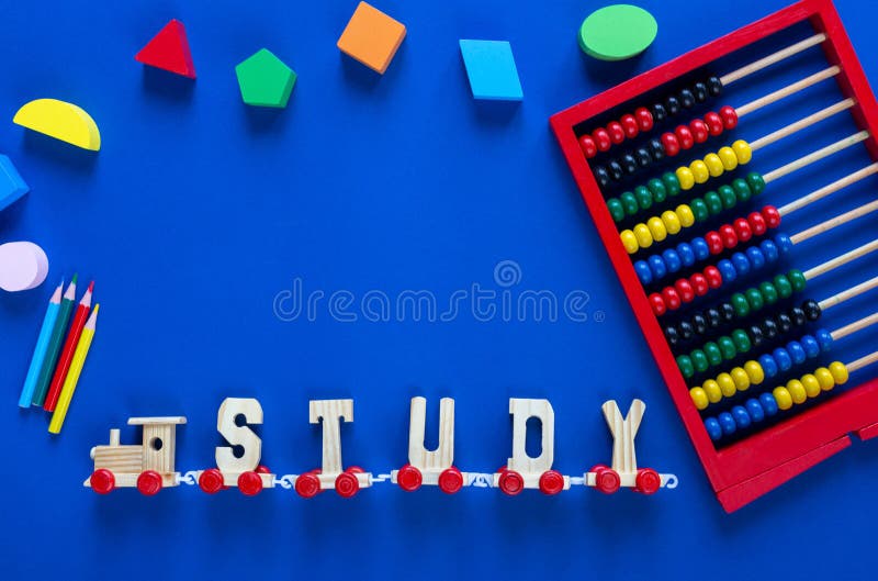 Wooden train with letters STUDY, pencils on classic blue background. Interesting, fun math for kids. Education, back to school