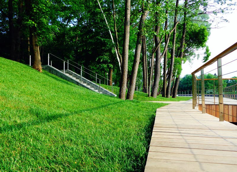 Wooden walking path with in well groomed green city park royalty free stock photography Wooden walking path with in well groomed green city park royalty free stock photography