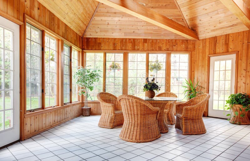 Wooden Wall Sun Room Interior. With Natural Wicker Furniture, Ceramic Tile floor stock photos