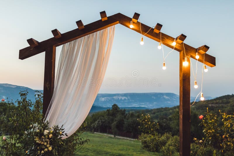 Wooden night wedding arch with light bulbs outdoor royalty free stock photos Wooden night wedding arch with light bulbs outdoor royalty free stock photos