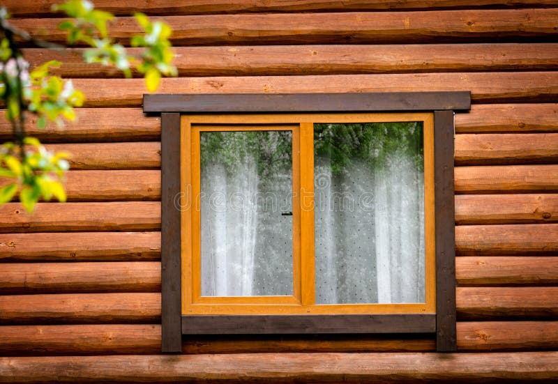Wooden Window on Facade of House Made of Wooden Beams. Pros and Cons of