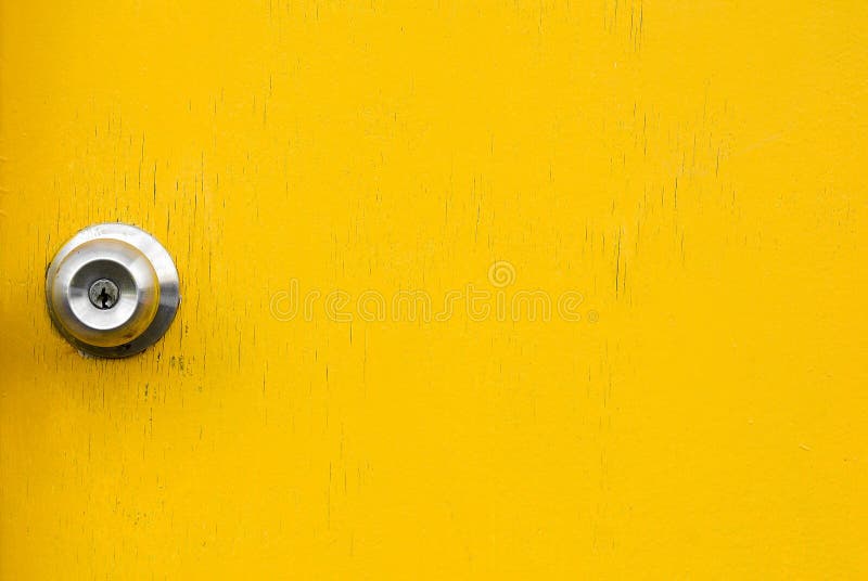 Wooden yellow door with old knob.