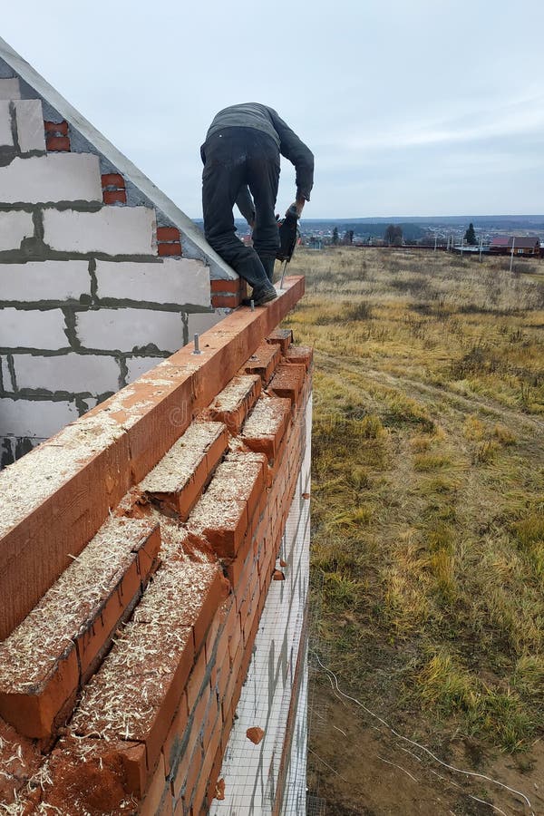 woodworker с цепной пилой делает выпил на конструкции деревянной балки домов стоковое фото woodworker с цепной пилой делает выпил на конструкции деревянной балки домов стоковое фото