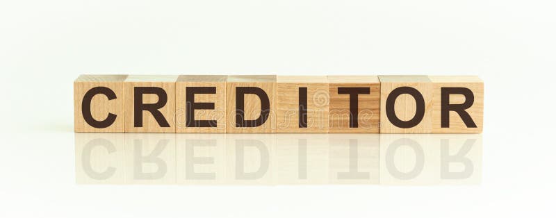 The word CREDITOR written on wooden cubes isolated on a white background stock photo