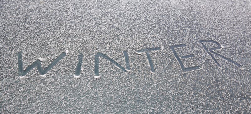 Word winter written on snowy car windshield. Word winter written on snowy car windshield