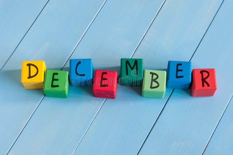 Word December On child's toy cubes on wooden rural background. Word December On child's toy cubes on wooden rural background