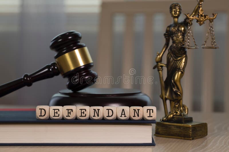 Word DEFENDANT composed of wooden dices. Wooden gavel and statue of Themis in the background stock images Word DEFENDANT composed of wooden dices. Wooden gavel and statue of Themis in the background stock images
