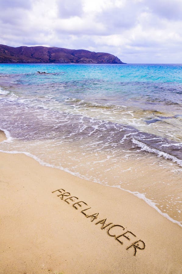 Word FREELANCER Written in Sand, on a Beautiful Beach Stock Image