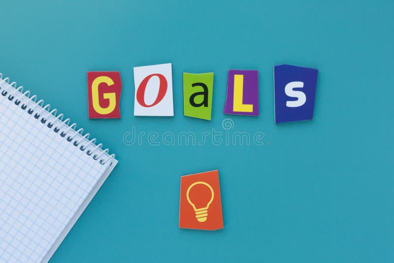 Word goals on blue background. Inscription goals of carved letters from the newspaper. A word writing text showing concept of goal stock images