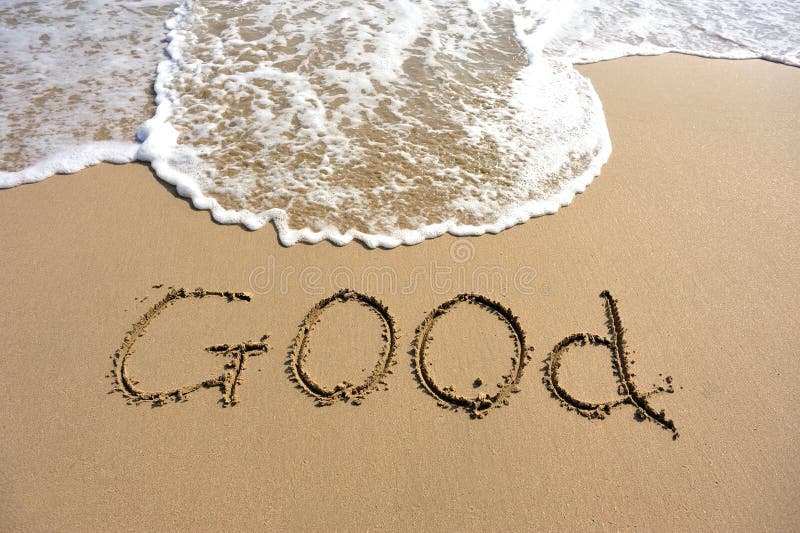 Word good drawn on the beach
