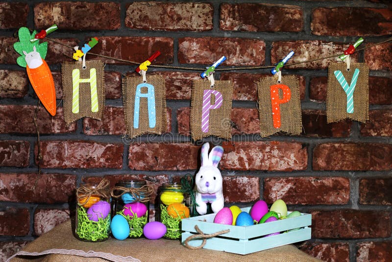 Word Happy on sackcloth tags hanging on a line with orange carrot, colorful Easter eggs in glass jars and white bunny rabbit stock photo Word Happy on sackcloth tags hanging on a line with orange carrot, colorful Easter eggs in glass jars and white bunny rabbit stock photo