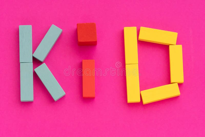 Word KID made from multicolored wooden bricks toys on purple paper background. Early childhood education and kids game