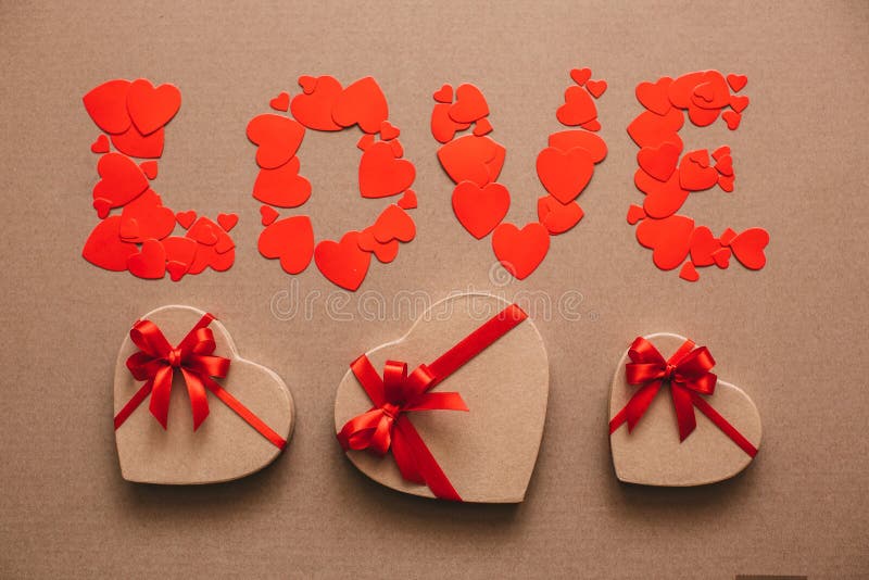 Word Love from hearts and gift boxes in the shape of hearts. Gifts for Valentine's Day. royalty free stock image Word Love from hearts and gift boxes in the shape of hearts. Gifts for Valentine's Day. royalty free stock image