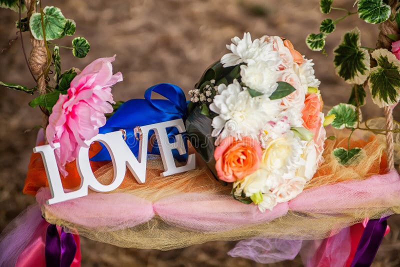 The word love in white wood and flowers