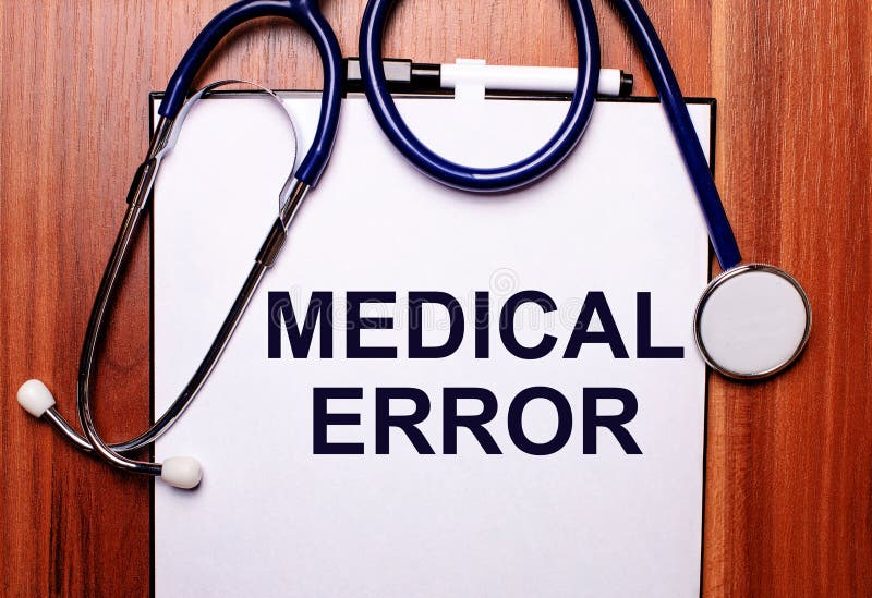 The Word MEDICAL ERROR is Written on White Paper on a Wooden Background ...