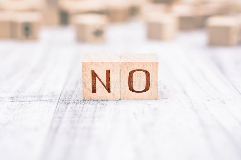 The Word No Formed By Wooden Blocks On A White Table