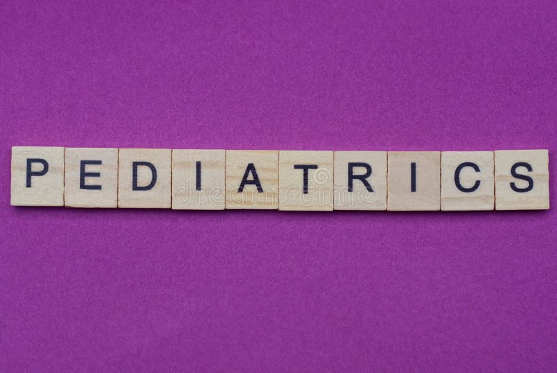 Word pediatrics from small gray wooden letters lies on a lilac background