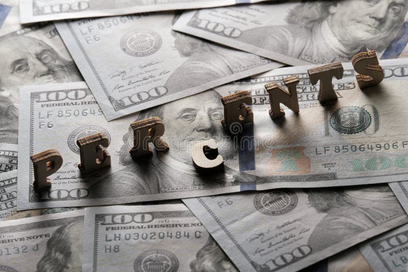 The word PERCENTS is lined with wooden letters on the background of hundred-dollar bills. The concept of financial transactions stock image The word PERCENTS is lined with wooden letters on the background of hundred-dollar bills. The concept of financial transactions stock image