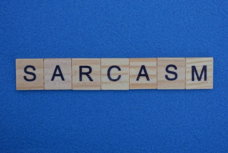 Word sarcasm made from gray wooden letters lies on a blue background