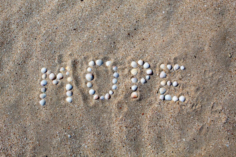 The word sea, in Russian, is laid out on the sand with shells. royalty free stock image The word sea, in Russian, is laid out on the sand with shells. royalty free stock image