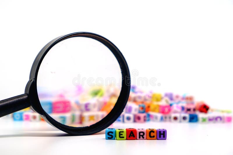 Word `SEARCH` on the magnifying glass with alphabet letter beads background, Search engine optimization concept