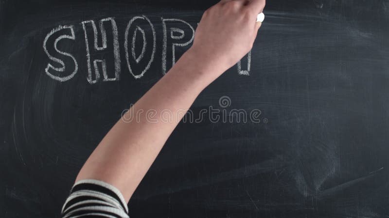 Word shopping is written in large letters chalk on chalkboard along with a shopping bag, a discount sign and the word