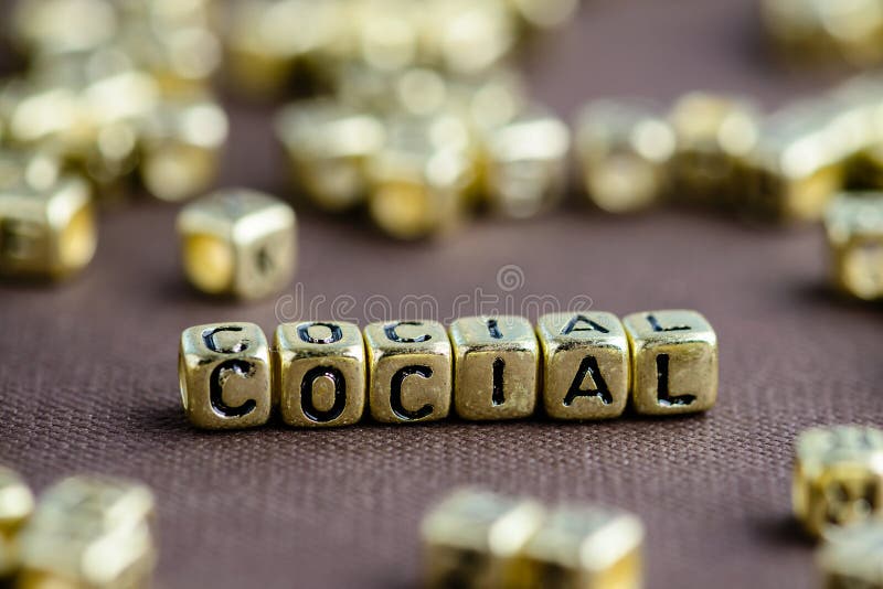 Word SOCIAL made from small golden letters on the brown backgrou stock image Word SOCIAL made from small golden letters on the brown backgrou stock image