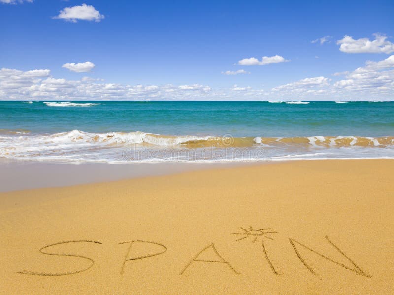 The word Spain written on the beach sand