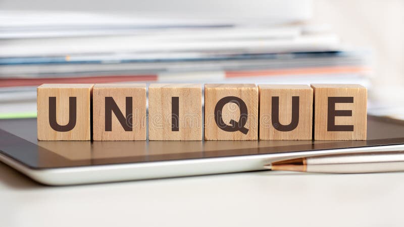 The word unique is written on wooden cubes, concept royalty free stock images