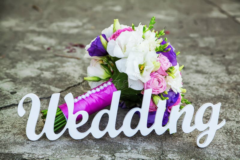 The word Wedding and bridal bouquet