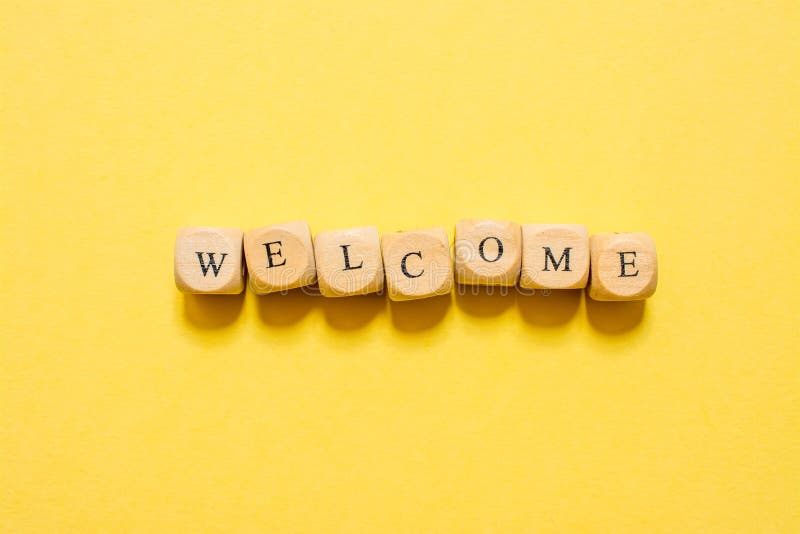 The word Welcome, text made with dice on yellow background stock photos