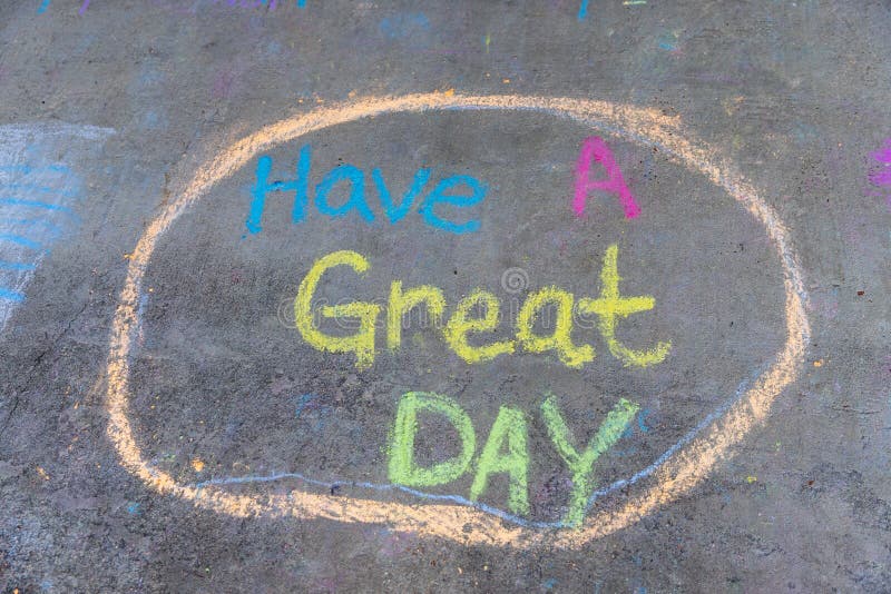 The words &#x22;Have a great day&#x22; written with sidewalk chalk on gray concrete pavement background. The words &#x22;Have a great day&#x22; written with sidewalk chalk on gray concrete pavement background