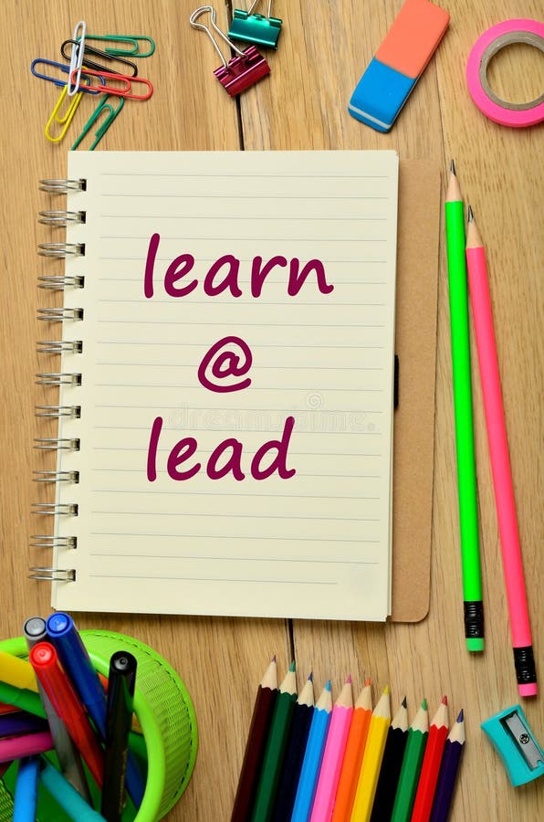 Words LEAD by EXAMPLE Written on Torn Paper on a Computer Keyboard