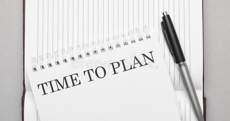 Words TIME TO PLAN text on notepad and pen royalty free stock photography