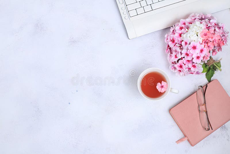 Work desk of a modern woman, home office. Notepad, tea, spring flowers on a light table. Minimal business concept, flat lay, place for text. Notepad composition stock images, royalty-free photos and pictures
