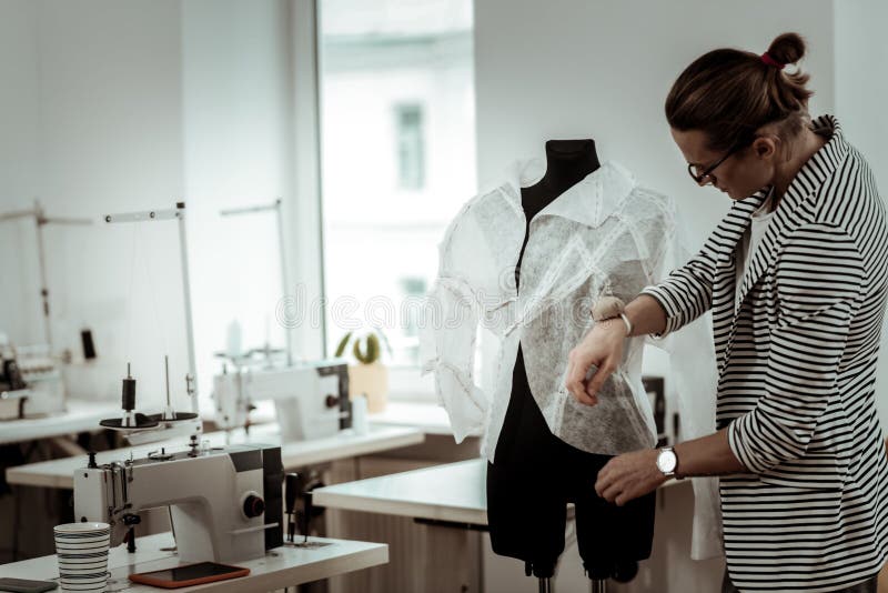 Handsome Young Fashion Dressmaker in Eyeglasses Putting the Blouse on a ...