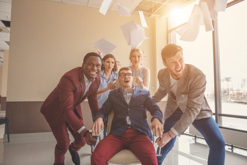 We are the winners. business people having fun while racing on office chairs stock image We are the winners. business people having fun while racing on office chairs stock image