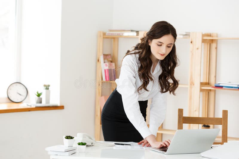 Work from home concept - Beautiful young woman in her home working on laptop. Working at home. Quarantine.