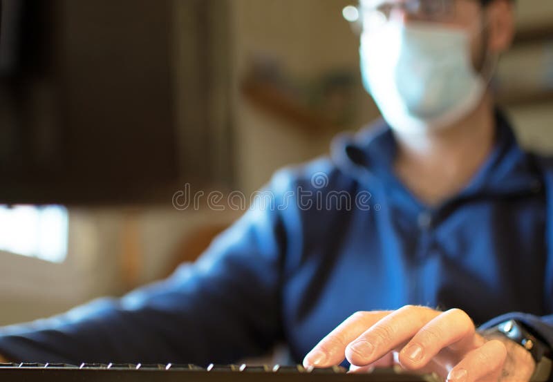 Work from home COVID-19 concept. Asia man wear medical mask using notebook computer working for social distancing meeting online