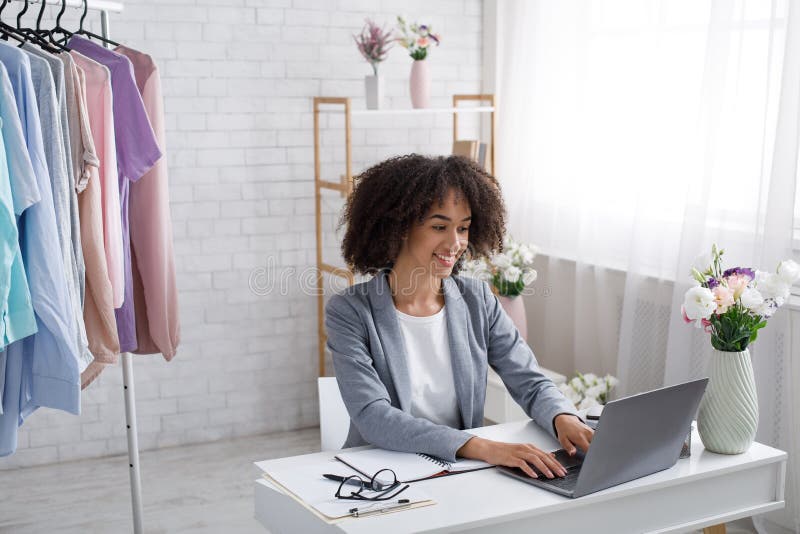 Work at home during covid-19 quarantine. Happy african american woman typing in laptop