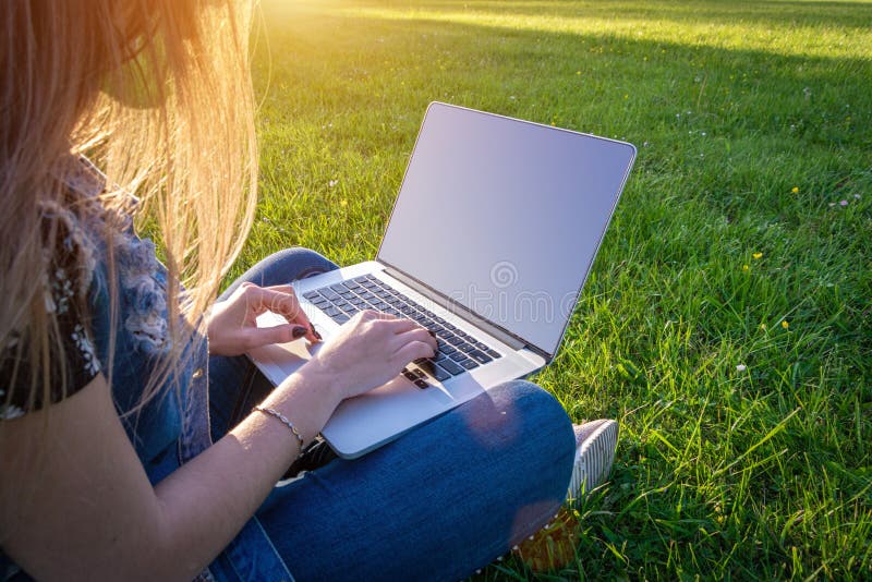 Work laptop outdoor. Student woman with computer, tablet in summer nature park. Girl does business with online technology outside