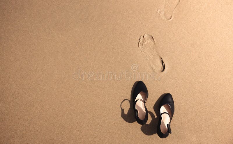 Work Life Balance Concept. Business Woman take off her Working Shoes and leave it on the Sand Beach for Walk into the Sea