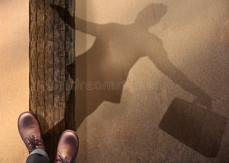 Work Life Balance Concept. Top View of Male Standing and Balancing his body on Wooden Log at the Beach. Blurred Shadow on Sand as