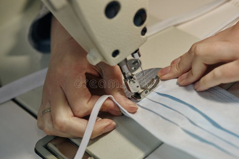 Work process of sewing masks for protection against coronavirus royalty free stock photo