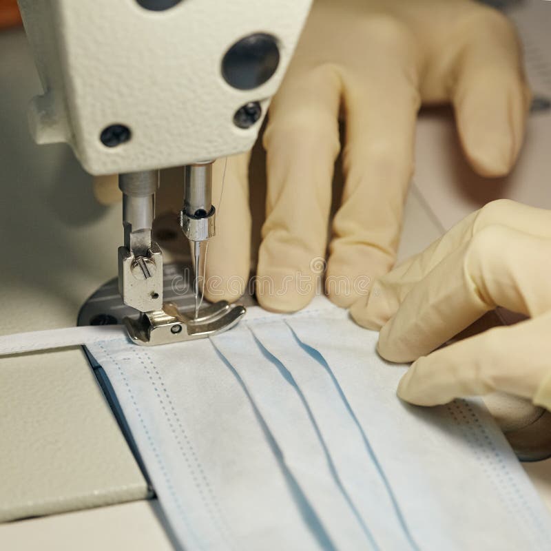 Work process of sewing masks for protection against coronavirus stock photography