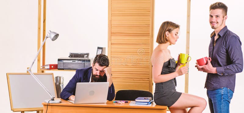 Work and rest balance. Young coworkers enjoying rest break at work. Pretty woman and handsome man having rest in office stock photos Work and rest balance. Young coworkers enjoying rest break at work. Pretty woman and handsome man having rest in office stock photos