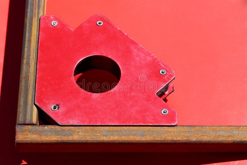 Welder Welding Angle Iron with Stick Electrode with Red and Blue