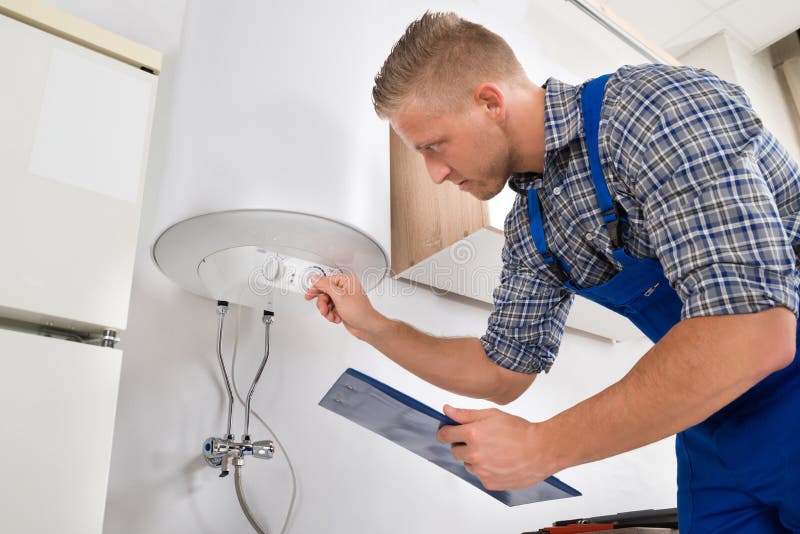 Worker Adjusting Temperature Of Water Heater