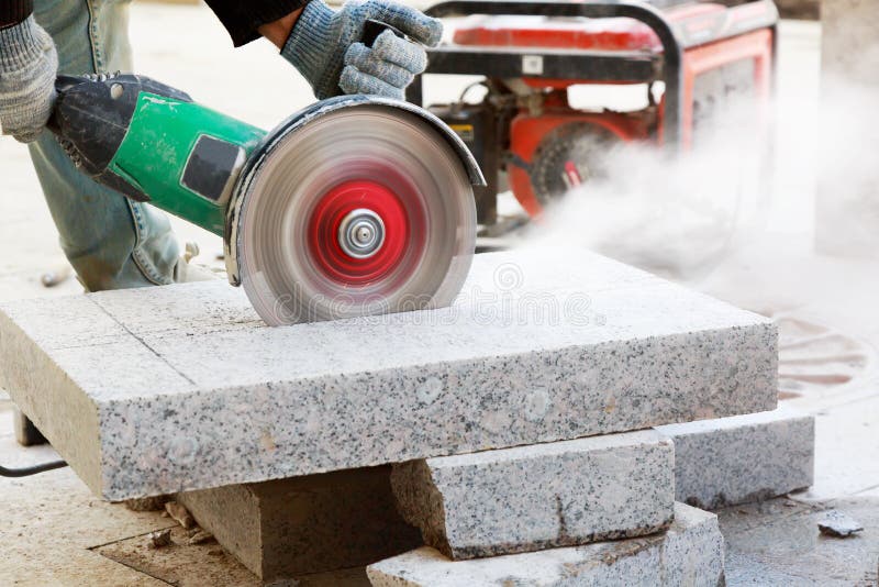 Worker Cutting Stone With Grinder. Dust While Grinding Stone Pavement