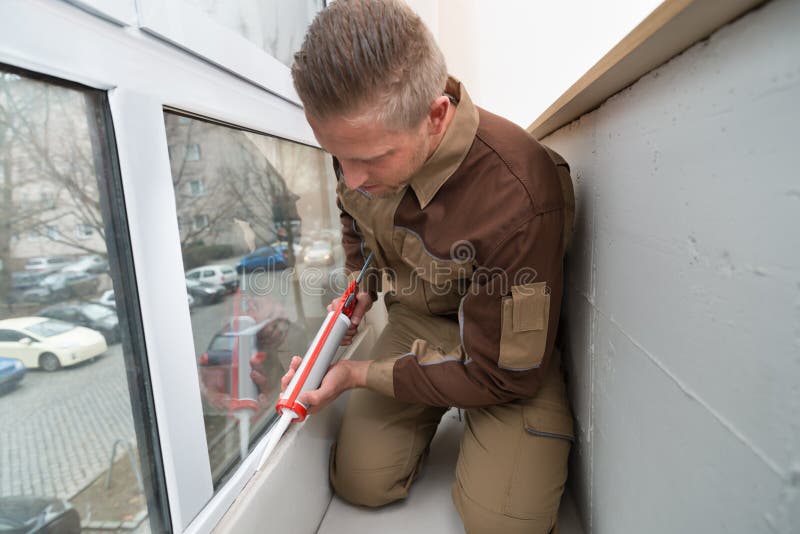 Worker Applying Glue With Silicone Gun stock images